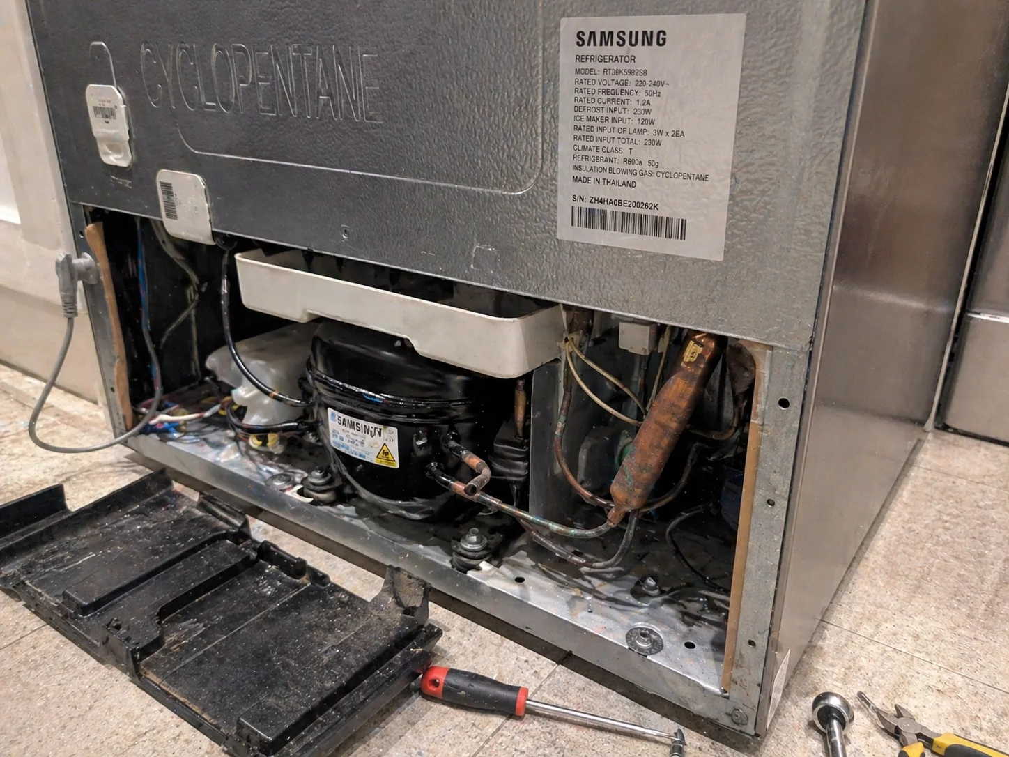 fridge repair with exposed compressor not cooling properly